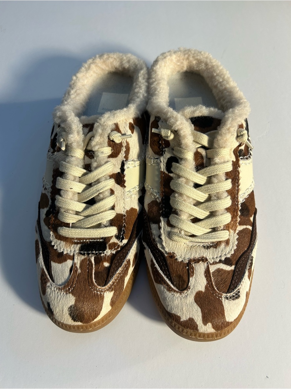 Dolce Vita Cow-Print Shearling Mules in Brown & Cream